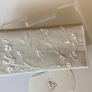 Beige fabric envelope embroidered with roses and birds in off-white
