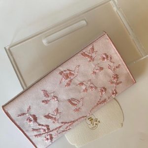 Pink fabric envelope embroidered with roses and birds