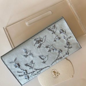 Blue fabric envelope embroidered with roses and birds