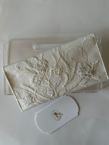 Off-white fabric envelope embroidered with off-white roses